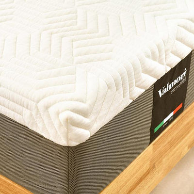 medium edge shot of a valmori mattress with its logo on one side